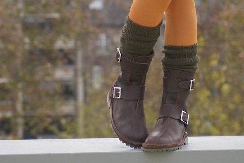girl in boots on wall